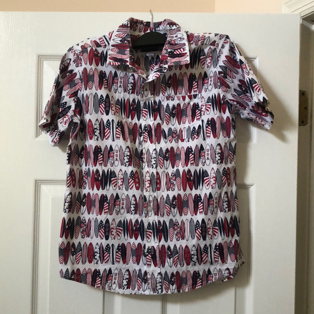 Boy’s short sleeve button down shirt with red white and blue surfboards design.